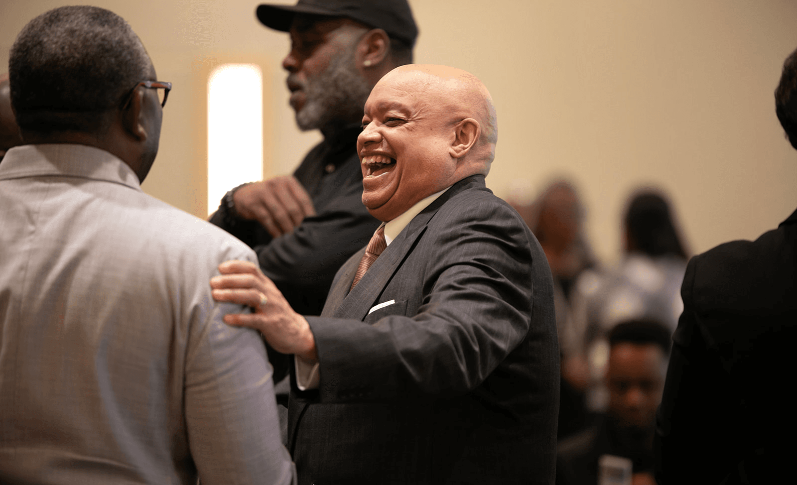 Two business leaders laughing together at an OMSDC networking event